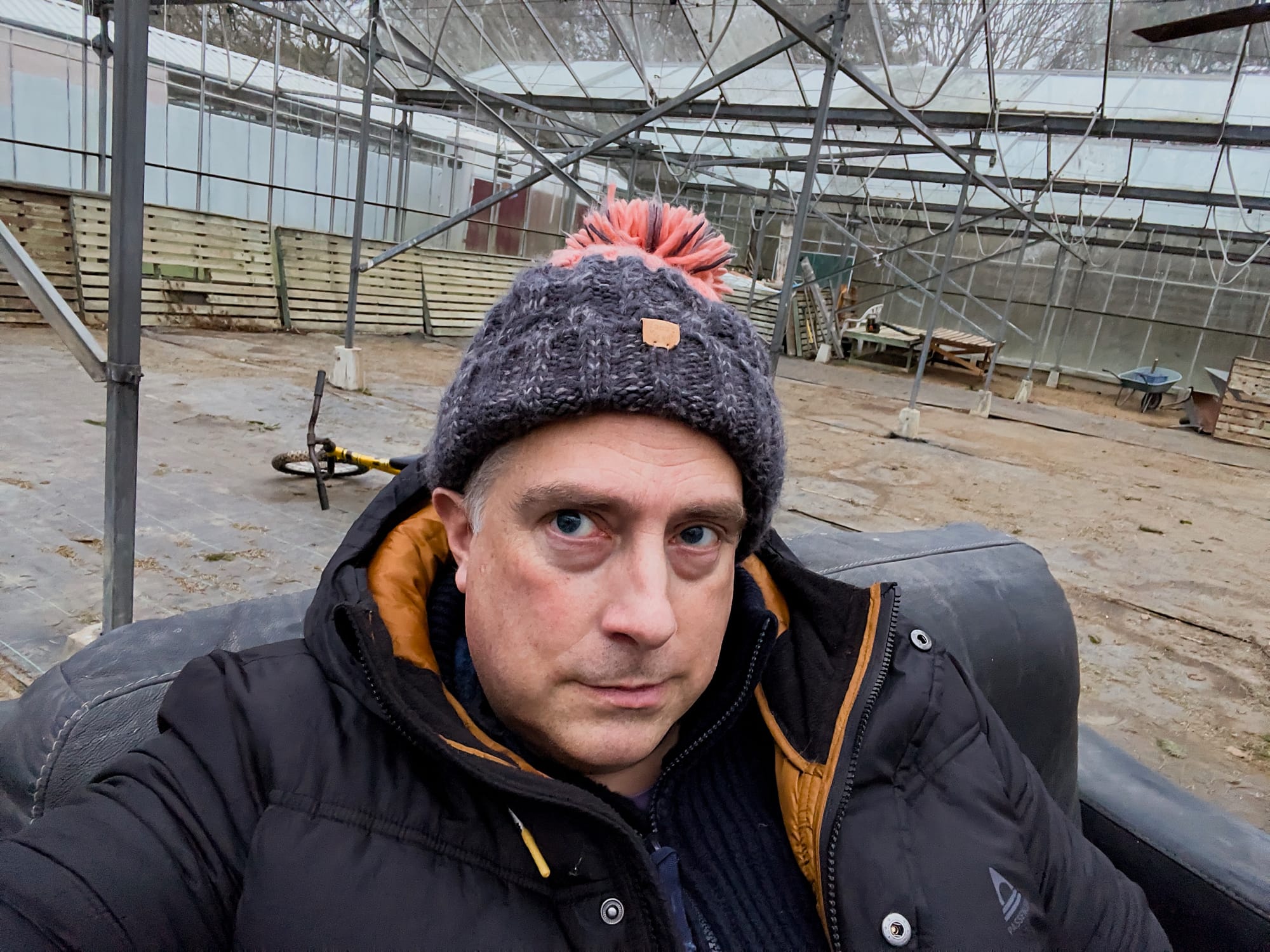 Adam Tinworth in winter clothes in an empty barn